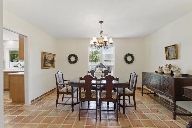 dining space with a chandelier and light tile patterned flooring