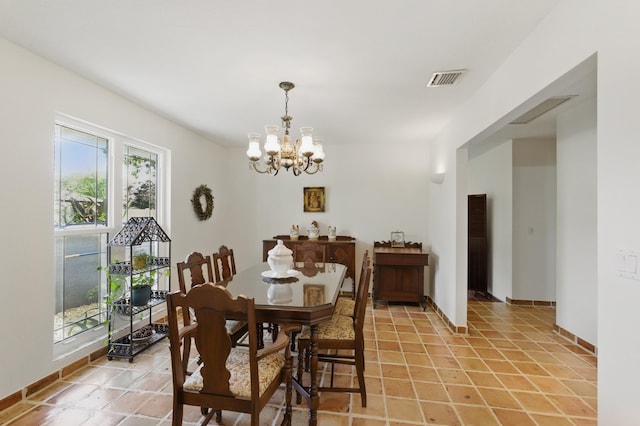 dining space with an inviting chandelier, visible vents, and baseboards