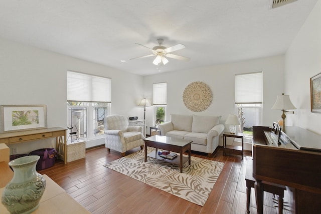 living area featuring visible vents, wood finished floors, and ceiling fan