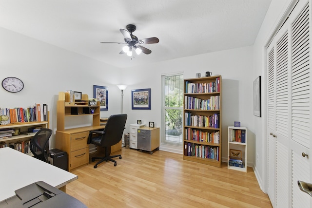 office space featuring a ceiling fan and light wood-style flooring