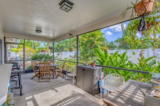 sunroom / solarium featuring outdoor dining area