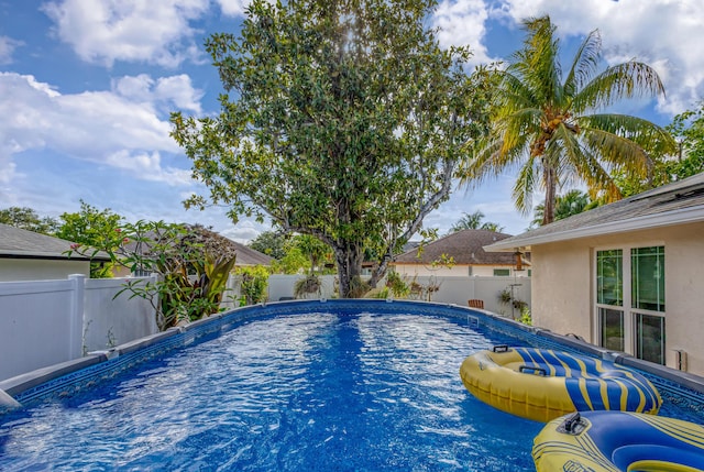 view of swimming pool with a fenced in pool and a fenced backyard