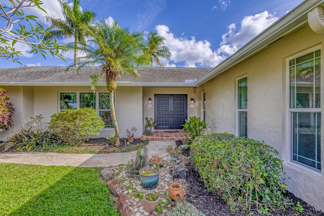 entrance to property featuring stucco siding