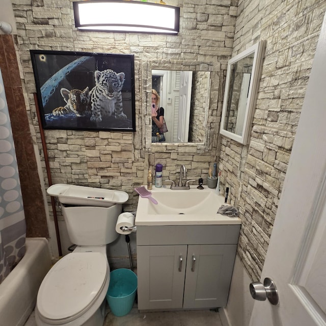 full bathroom with vanity, shower / bath combo, and toilet