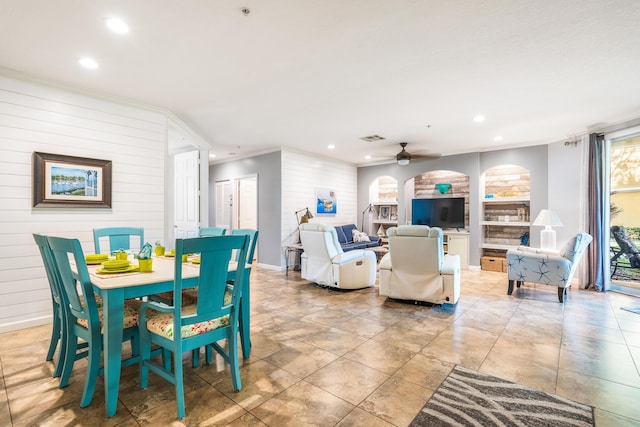 dining room featuring baseboards, recessed lighting, ornamental molding, a ceiling fan, and built in shelves