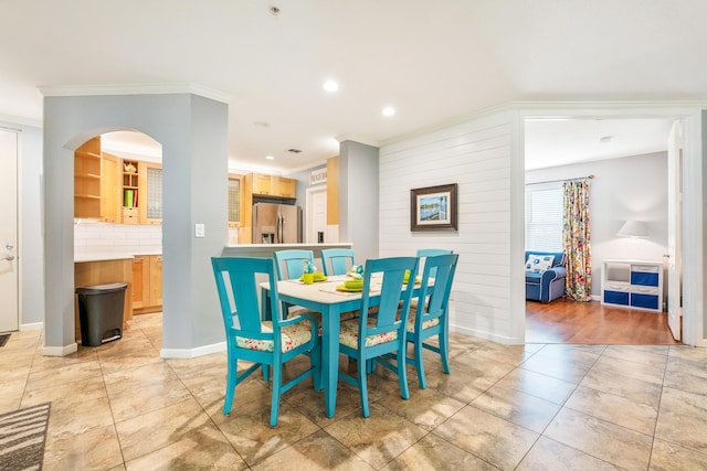 dining room with crown molding, recessed lighting, baseboards, and light tile patterned floors