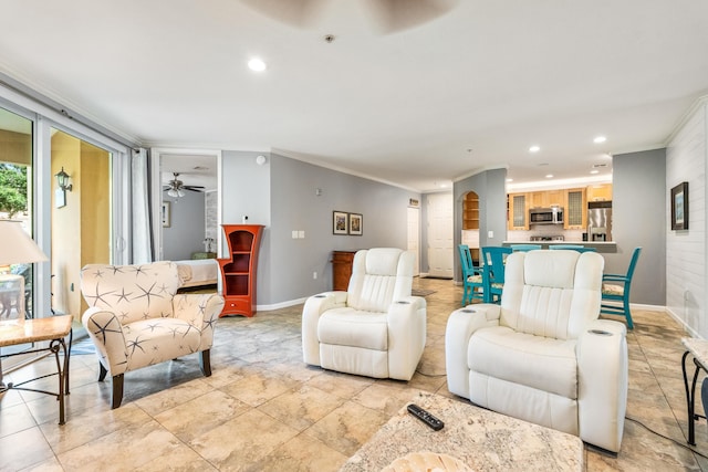 living room with ornamental molding, recessed lighting, baseboards, and a ceiling fan