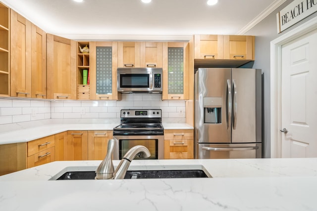 kitchen with stainless steel appliances, open shelves, backsplash, light stone counters, and a sink