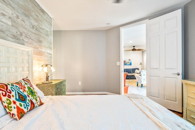 bedroom featuring wood walls