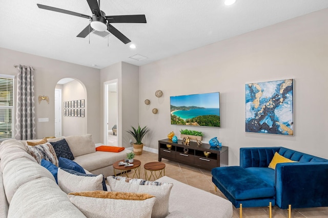 10327 SW W Park Ave, Port Saint Lucie, FL 34987 - living room featuring arched walkways, light tile patterned flooring, a ceiling fan, recessed lighting, and baseboards