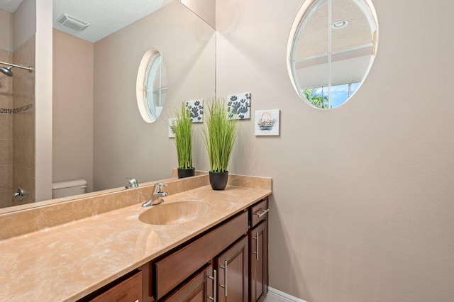 10327 SW W Park Ave, Port Saint Lucie, FL 34987 - bathroom with toilet, vanity, a shower, and baseboards