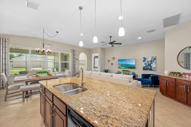 10327 SW W Park Ave, Port Saint Lucie, FL 34987 - kitchen with a sink, decorative light fixtures, light stone counters, and a chandelier