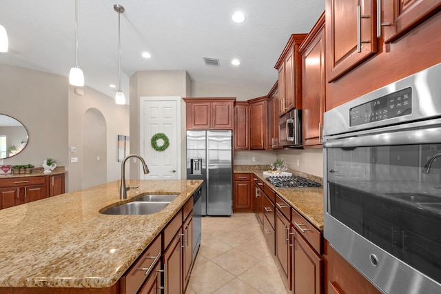 10327 SW W Park Ave, Port Saint Lucie, FL 34987 - kitchen with stainless steel appliances, a sink, arched walkways, light stone counters, and pendant lighting