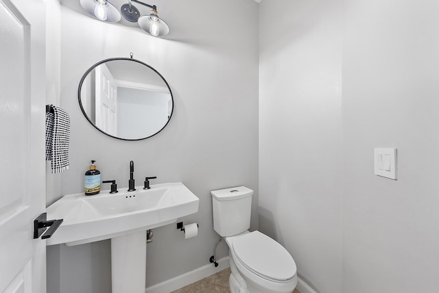 5769 SE Crooked Oak Ave, Hobe Sound, FL 33455 - bathroom with toilet, tile patterned floors, and baseboards