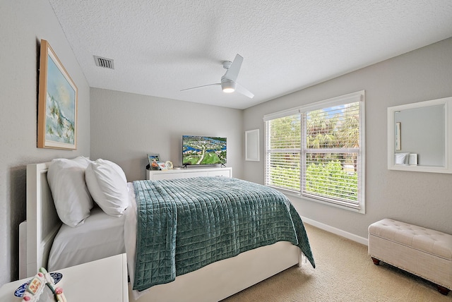 5769 SE Crooked Oak Ave, Hobe Sound, FL 33455 - bedroom with carpet, ceiling fan, a textured ceiling, and baseboards