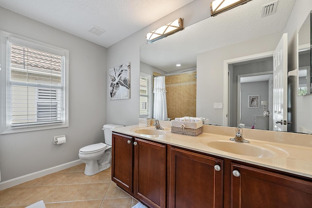 5769 SE Crooked Oak Ave, Hobe Sound, FL 33455 - bathroom featuring tile patterned flooring, toilet, baseboards, tiled shower, and double vanity