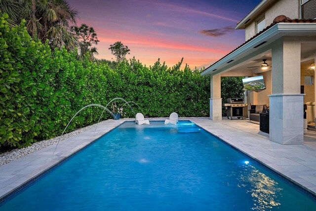 5769 SE Crooked Oak Ave, Hobe Sound, FL 33455 - view of pool featuring a patio area, ceiling fan, a grill, and an outdoor kitchen