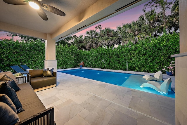 outdoor pool featuring a patio and a ceiling fan