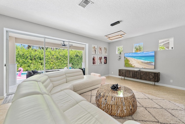5769 SE Crooked Oak Ave, Hobe Sound, FL 33455 - living room featuring baseboards and a textured ceiling