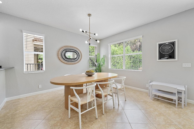 5769 SE Crooked Oak Ave, Hobe Sound, FL 33455 - dining area featuring light tile patterned floors, baseboards, and a textured ceiling