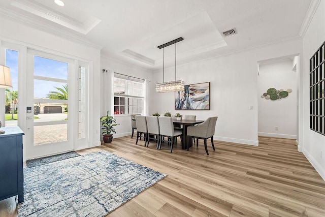 132 Steeple Cir, Jupiter, FL 33458 - dining room with a tray ceiling, crown molding, light wood-type flooring, a chandelier, and baseboards
