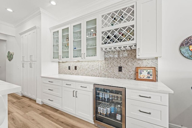 132 Steeple Cir, Jupiter, FL 33458 - indoor dry bar with wine cooler, ornamental molding, backsplash, light wood-style floors, and recessed lighting