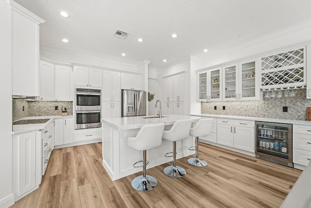 132 Steeple Cir, Jupiter, FL 33458 - kitchen featuring wine cooler, appliances with stainless steel finishes, crown molding, tasteful backsplash, and white cabinetry