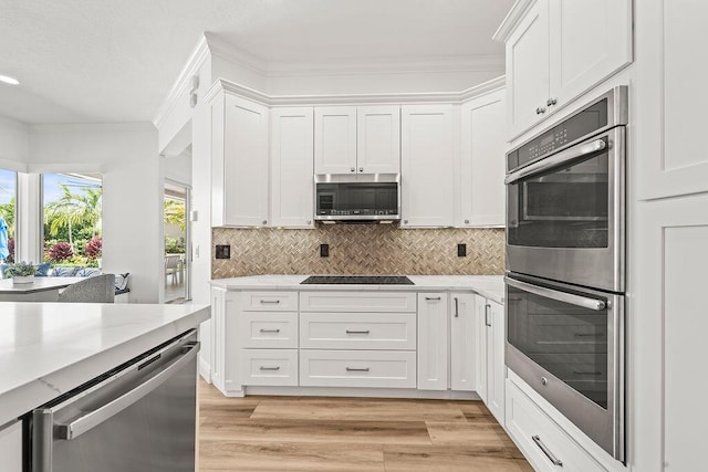 132 Steeple Cir, Jupiter, FL 33458 - kitchen featuring appliances with stainless steel finishes, white cabinets, and crown molding