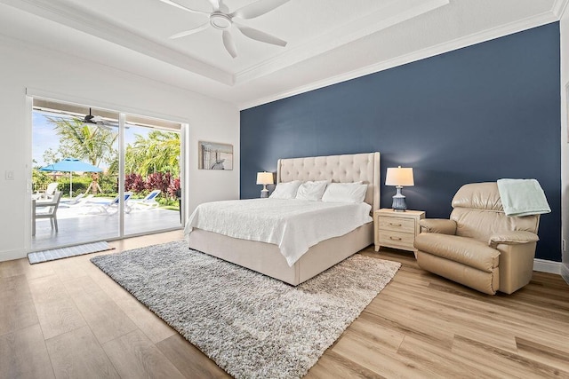 132 Steeple Cir, Jupiter, FL 33458 - bedroom with access to exterior, a tray ceiling, light wood-style floors, ornamental molding, and baseboards