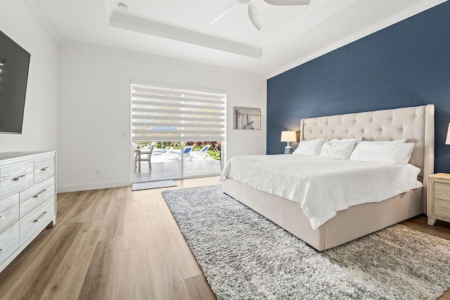 132 Steeple Cir, Jupiter, FL 33458 - bedroom featuring access to outside, wood finished floors, a tray ceiling, ornamental molding, and a ceiling fan