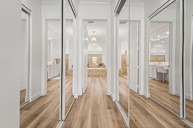 132 Steeple Cir, Jupiter, FL 33458 - hallway featuring light wood-style floors and crown molding