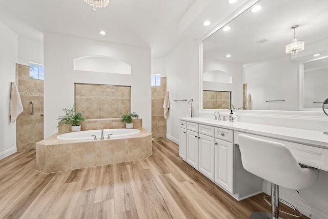 132 Steeple Cir, Jupiter, FL 33458 - bathroom featuring a garden tub, vanity, wood finished floors, recessed lighting, and a tile shower