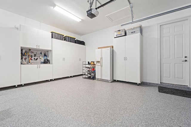 132 Steeple Cir, Jupiter, FL 33458 - garage featuring white refrigerator with ice dispenser and a garage door opener