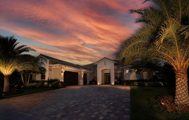 132 Steeple Cir, Jupiter, FL 33458 - mediterranean / spanish-style house with a garage, decorative driveway, and stucco siding