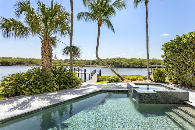 view of pool featuring a water view, a boat dock, boat lift, and a pool with connected hot tub