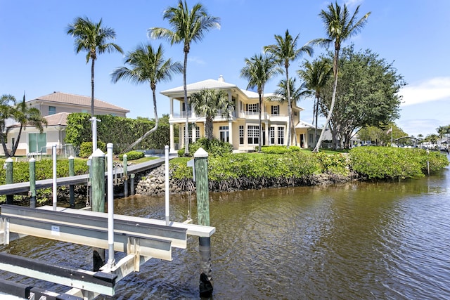 dock featuring a balcony, a water view, and boat lift