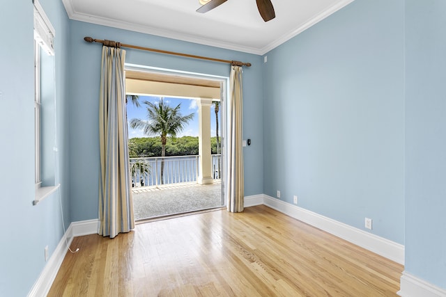 empty room with light wood-type flooring, ceiling fan, baseboards, and ornamental molding