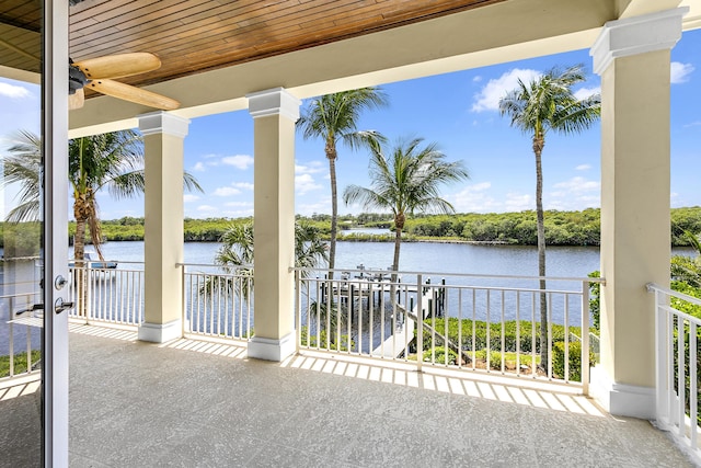 view of patio with a water view and a balcony