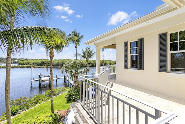 view of patio with a water view, a dock, and boat lift