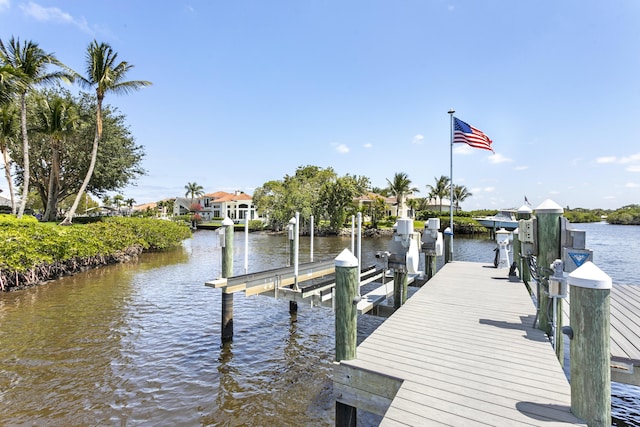 dock featuring boat lift and a water view
