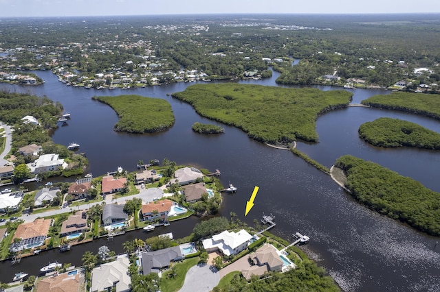 aerial view of property and surrounding area featuring a large body of water and nearby suburban area