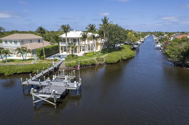 dock area with boat lift, a water view, and an outdoor pool