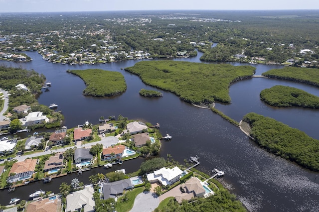 aerial view of property and surrounding area featuring a large body of water and nearby suburban area