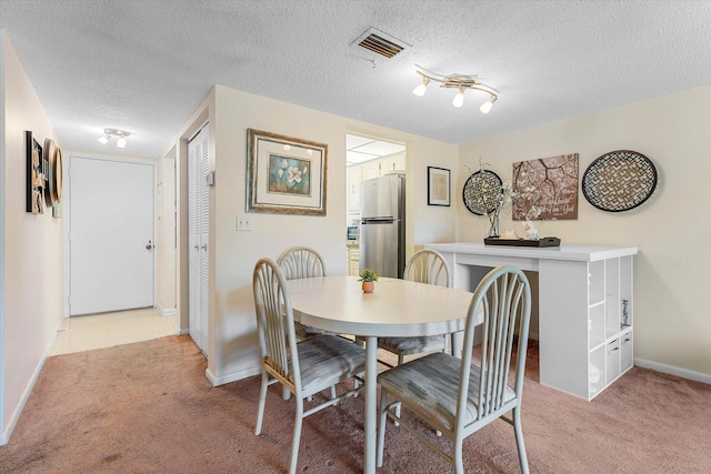 18081 SE Country Club Dr Unit 130, Jupiter, FL 33469 - dining space featuring light carpet, baseboards, and a textured ceiling
