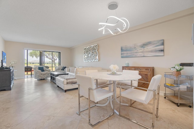 7240 Huntington Ln Unit 105, Delray Beach, FL 33446 - dining area with a chandelier and light tile patterned floors