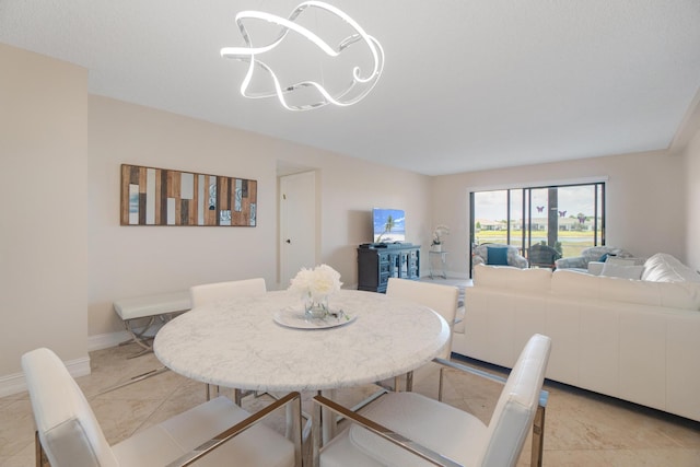 7240 Huntington Ln Unit 105, Delray Beach, FL 33446 - dining room with baseboards and a chandelier