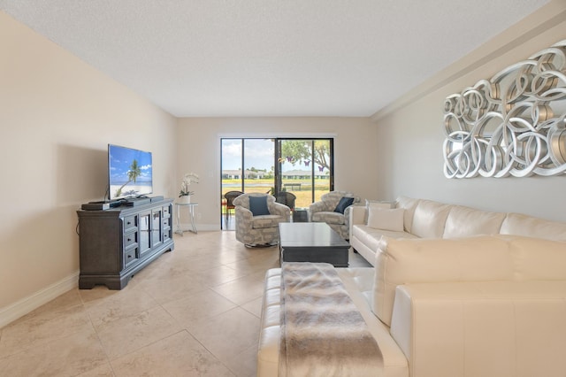 7240 Huntington Ln Unit 105, Delray Beach, FL 33446 - living room featuring baseboards and light tile patterned floors