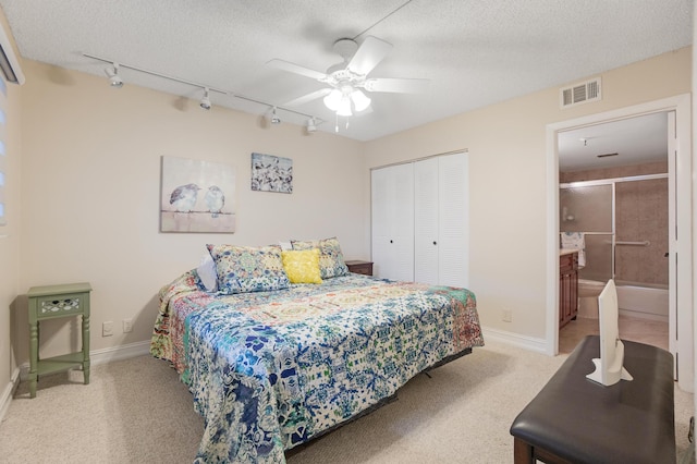 7240 Huntington Ln Unit 105, Delray Beach, FL 33446 - bedroom with light colored carpet, rail lighting, visible vents, and a closet
