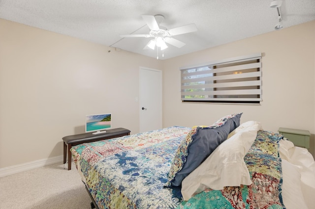 7240 Huntington Ln Unit 105, Delray Beach, FL 33446 - bedroom with a ceiling fan, carpet, a textured ceiling, baseboards, and track lighting