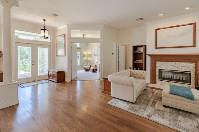 8005 SW Yachtsmans Dr, Stuart, FL 34997 - living area with ornamental molding, wood finished floors, decorative columns, french doors, and a glass covered fireplace